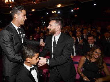 Bintang Real Madrid, Cristiano Ronaldo, berbincang dengan striker Barcelona, Lionel Messi, saat acara penghargaan pemain terbaik FIFA 2017 di London, Senin (23/10/2017). Cristiano Ronaldo berhasil meraih pemain terbaik FIFA 2017. (AFP/Ben Stansall)