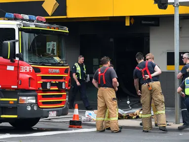 Petugas layanan darurat terlihat di lokasi kebakaran yang terjadi di kantor cabang Commonwealth Bank of Australia, di Melbourne , Jumat (18/11). Kejadian ini menyebabkan 27 orang terluka dan enam lainnya dinyatakan kritis. (AAP/Julian Smith/via REUTERS) 