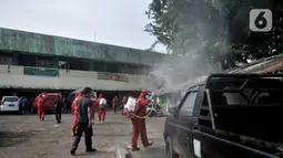 Pedagang menyaksikan petugas pemadam kebakaran Jakarta Pusat menyemprotkan disinfektan di Pasar Rawasari, Jakarta, Kamis (11/6/2020). Pihak pengelola menutup Pasar Rawasari selama tiga hari ke depan guna mensterilisasi serta memutus penyebaran Covid-19. (merdeka.com/Iqbal S. Nugroho)