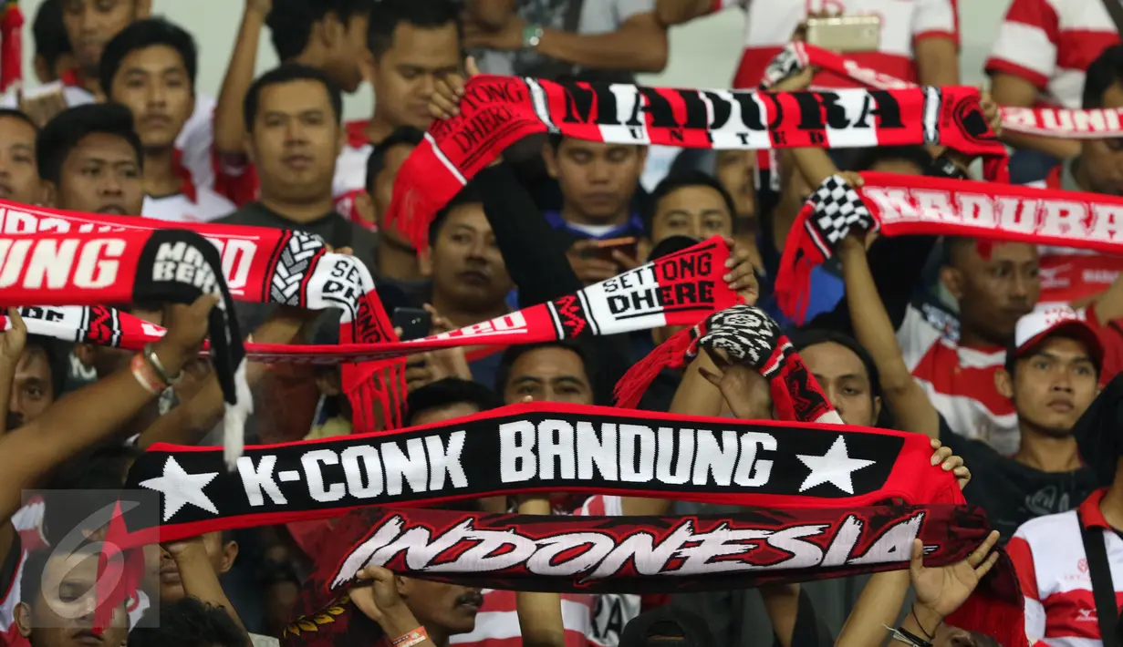 Suporter Madura United membentangkan syal jelang menyaksikan timnya berlaga melawan Persija pada lanjutan Liga 1 di Stadion Patriot Candrabhaga, Bekasi, Kamis (4/5). Madura United FC unggul 1-0. (Liputan6.com/Helmi Fithriansyah)