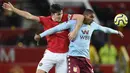 Bek Manchester United, Harry Maguire, berebut bola dengan striker Aston Villa, Wesley, pada laga Premier League di Stadion Old Trafford, Manchester, Minggu (1/12). Kedua klub bermain imbang 2-2. (AFP/Oli Scarff)
