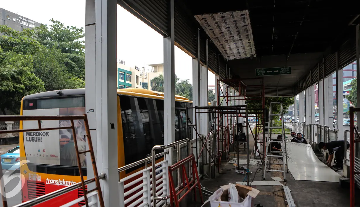 Pekerja menyelesaikan perbaikan halte transjakarta yang terbakar di Salemba, Jakarta, Selasa (7/7/2015). Halte tersebut rusak parah sebagai imbas dari terbakarnya bus Transjakarta koridor 5 pada hari Jumat (3/7) lalu. (Liputan6.com/Faizal Fanani)
