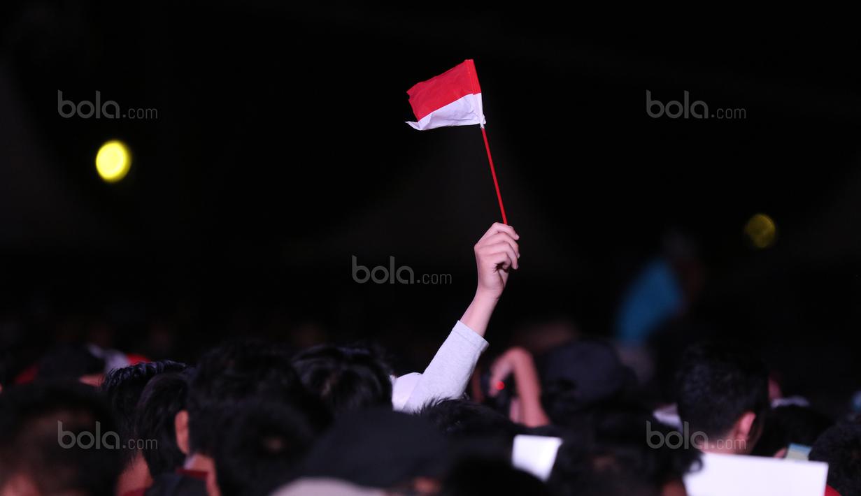 Penonton membawa bendera Merah-Putih saat menantikan Countdown Asian Games 2018 di Silang Monas, Jakarta, (18/8/2017), Asian Games 2018 memiliki tema Energy Of Asia. (Bola.com/Nicklas Hanoatubun)