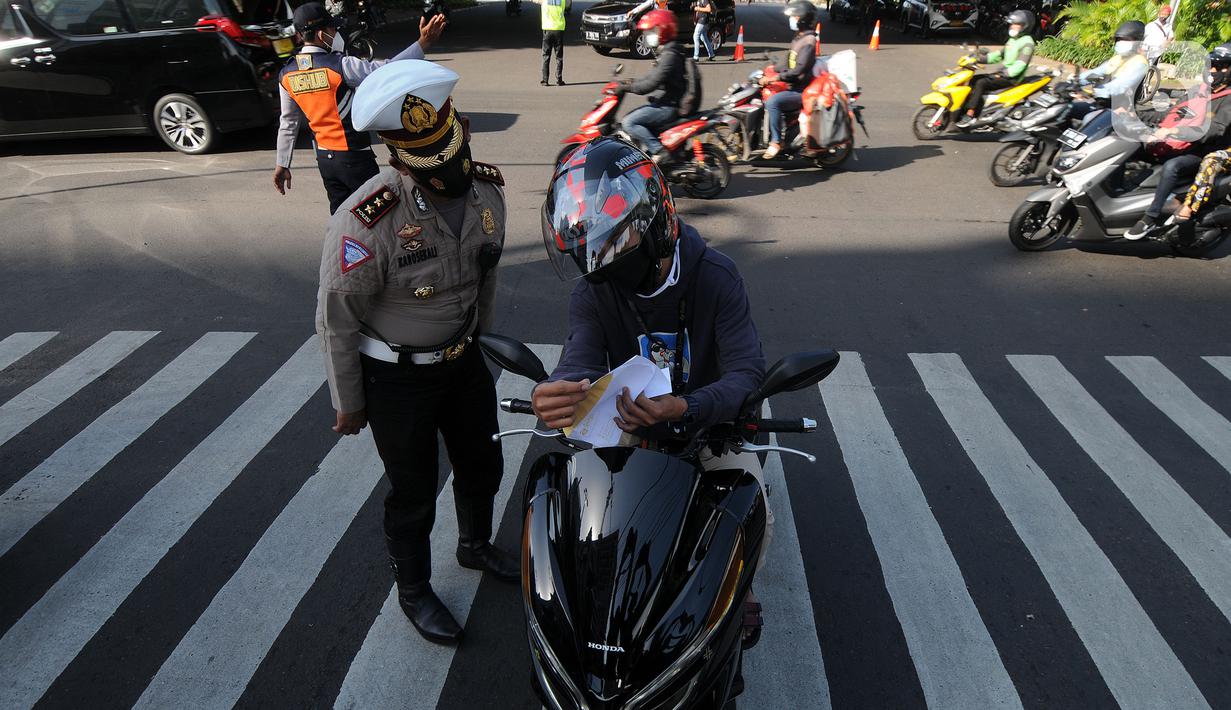 Polisi memberhentikan pengendara sepeda motor saat penyekatan masa PPKM Darurat di Perempatan Fatmawati, Jakarta, Senin (12/7/2021). Penyekatan berlangsung hingga pukul 10.00 WIB. (merdeka.com/Arie Basuki)