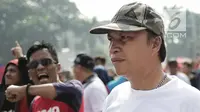 Massa berkaus #DiaSibukKerja melintas saat massa berkaus #2019GantiPresiden meneriakan yel-yel ganti presiden pada Car Free Day di Bundaran HI, Jakarta, Minggu (29/4). Saling sindir tak terelakan saat kedua aksi ini bertemu. (Liputan6.com/Faizal Fanani)