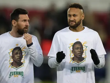 Penyerang Paris Saint-Germain (PSG) Lionel Messi berbicara dengan Neymar mengenakan kaos dengan potret mendiang legenda sepak bola Brasil Pele sebelum lanjutan Liga Prancis 2022/2023 melawan Angers di Parc des Princes, Kamis (12/1/2023) dini hari WIB. Para pemain PSG memberikan tribute spesial untuk Edson Arantes do Nascimento atau lebih dikenal sebagai Pele. (AP Photo/Francois Mori)