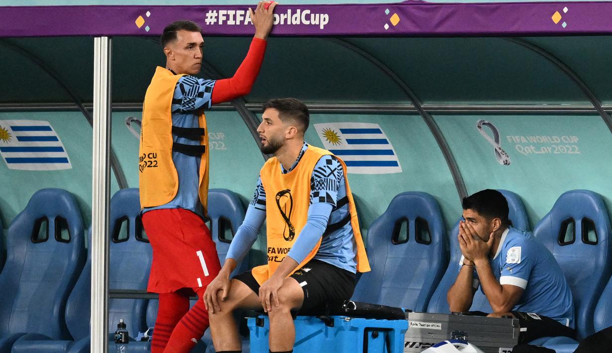 Luis Suarez yang merupakan mantan pemain Barcelona tersebut berulangkali menundukkan kepala, menutupi wajahnya dengan kostum pemain cadangan. Uruguay pun gagal melangkah ke 16 besar Piala Dunia 2022 meski berhasil meraih kemenangan dalam laga terakhir mereka di Grup H Piala Dunia 2022. (AFP/Raul Arboleda)