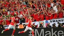 Pemain Wales, Aaron Ramsey (kanan) merayakan golnya ke gawang Rusia  pada laga grup B Euro cup 2016 di Stadion Municipal, Toulouse, Selasa (21/6/2016) dini hari WIB. Wales menang 3-0. (AFP/ Pascal Guyot)