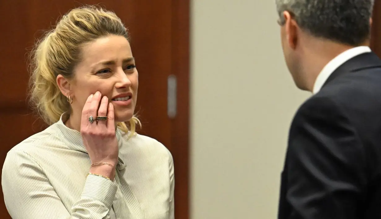 Aktris Amber Heard terlihat saat persidangan di Fairfax County Circuit Courthouse, Fairfax, Virginia, Amerika Serikat, 19 April 2022. Amber Heard menyebut Johnny Depp sebagai “figur publik yang mewakili kekerasan dalam rumah tangga.” (JIM WATSON/POOL/AFP)