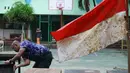 Guru membersihkan meja pascabanjir yang merendam SMA Negeri 8 Jakarta di Bukit Duri, Tebet, Jakarta, Sabtu (4/1/2020). Data Kemendikbud menyebutkan per 3 Januari 2020 terdapat 290 sekolah terdampak banjir di wilayah DKI Jakarta. (Liputan6.com/Herman Zakharia)