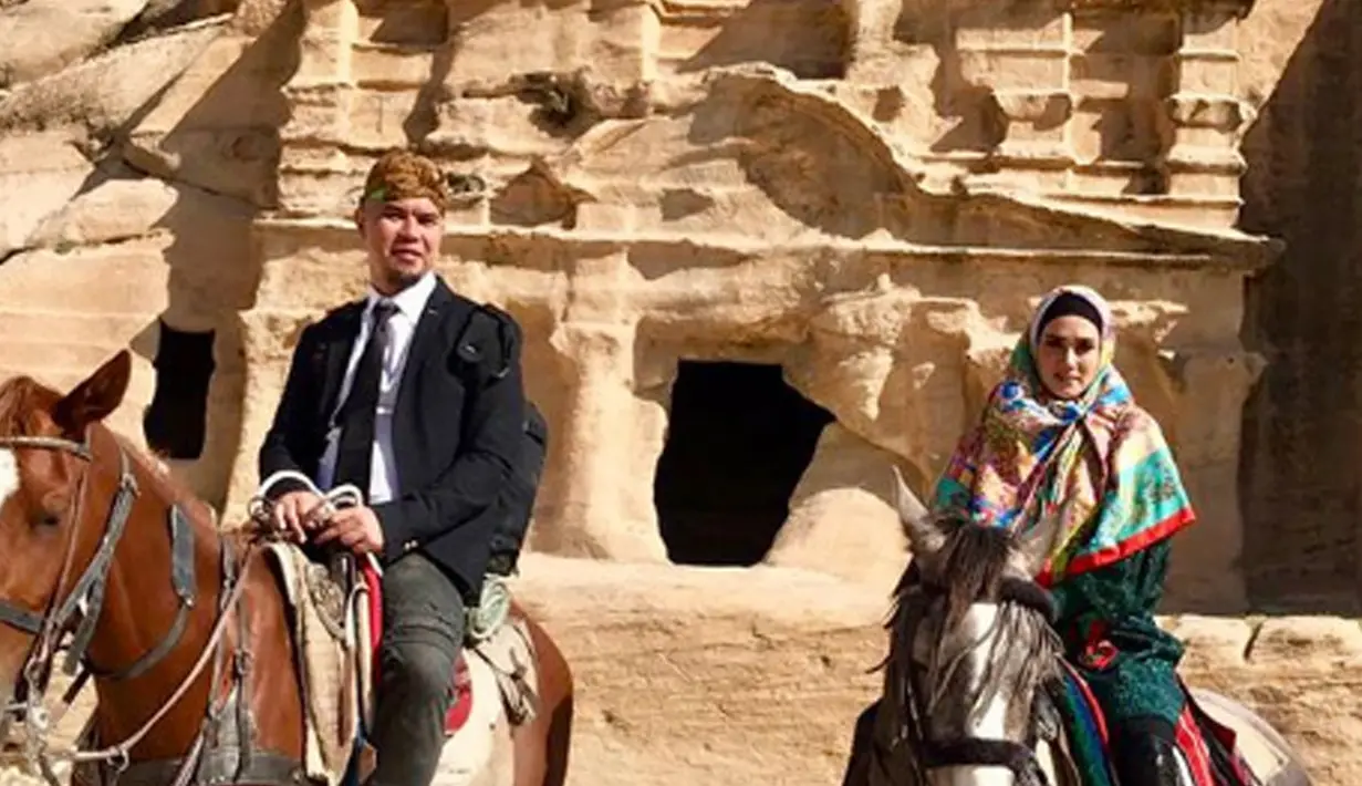Penyanyi Mulan Jameela dan Ahmad Dhani foto bersama sambil menunggangi kuda di depan situs bersejarah Petra yang berada di Amman, Yordania. (Instagram/@mulanjameela1)