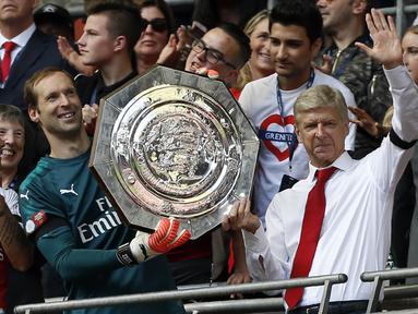 Pelatih Arsenal, Arsene Wenger, bersama kiper Petr Cech, mengangkat trofi Community Shield usai mengalahkan Chelsea di Stadion Wembley, London, Minggu (6/8/2017). Ini merupakan trofi Community Shield yang ke-15 bagi Arsenal. (AFP/Ian Kington)
