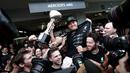 Pebalap Mercedes, Nico Rosberg, merayakan kemenangan bersama kru Mercedes pada balapan F1 GP Jepang di Sirkuit Suzuka, Minggu (9/10/2016). (AFP/Behrouz Mehri)