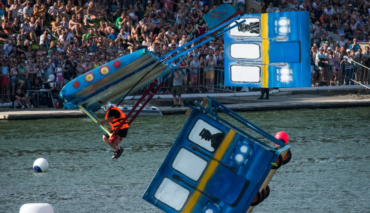 Peserta mengendarai pesawat mainan terjun bebas saat mengikuti Flugtag 2017 di Moskow, Rusia (13/8). Dalam aksinya, seluruh peserta lomba lepas landas dari sebuah kapal tongkang yang berakhir dengan terjun ke dalam air. (AFP Photo/Yuri Kadobnov)