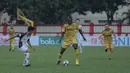 Pemain Bhayangkara FC, Herman Dzumafo (tengah) mencoba melewati pemain PS Tira pada lanjutan Liga 1 2018 di Stadion PTIK, Jakarta, Jumat (4/5/2018). Bhayangkara menang 4-2.  (Bola.com/Nick Hanoatubun)