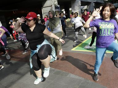 Sejumlah warga mengikuti senam Zumba di Kawasan Semanggi, Jakarta, Minggu (6/10/2019). Selain bisa membakar kalori dan bermanfaat untuk kesehatan jantung, olahraga ini juga bisa mencegah stress dan memperbaiki mood. (Bola.com/M Iqbal Ichsan)