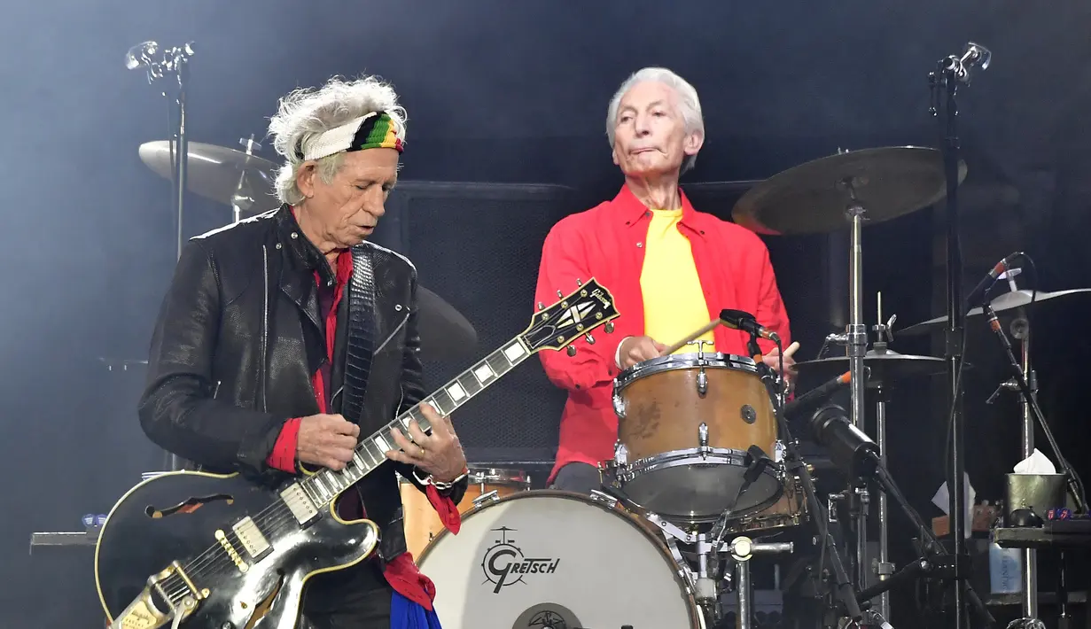 Personel The Rolling Stones Charlie Watts (kanan) dan Keith Richards (kiri) tampil dalam konser di Stadion Olimpiade Berlin, Jerman, 22 Juni 2018. The Rolling Stones pun mengenang sosok Chalie Watts sebagai salah satu drummer terbaik pada eranya. (Tobias SCHWARZ/AFP)