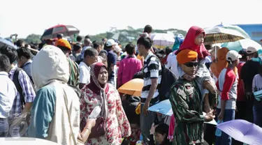 Masyarakat menyaksikan atraksi dalam Hut TNI-AU ke-71 di Taxi Way Skuadron Udara Bandara Halim Perdanakusuma, Jakarta, Minggu (9/4). Dalam rangka memperingati HUT ke-71, TNI AU memamerkan atraksi ratusan pesawat. (Liputan6.com/Faizal Fanani)