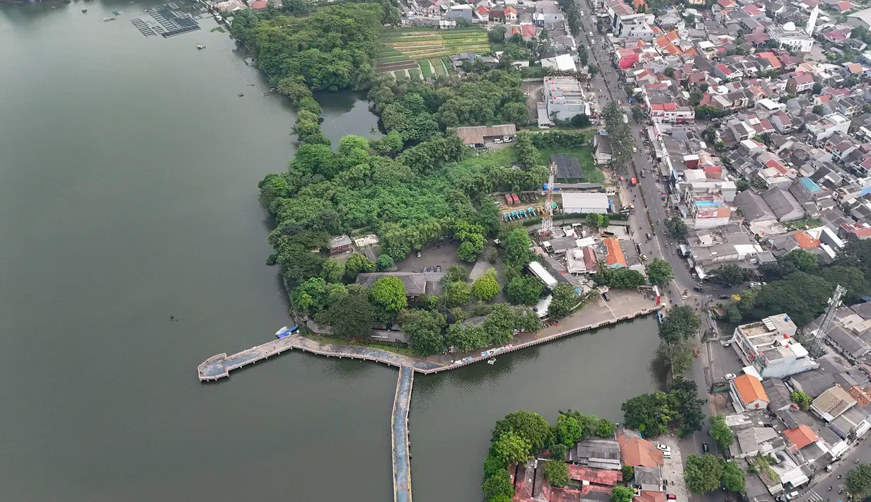 Lanskap air yang luas dipadukan dengan ruang hijau menjadikannya pilihan bagi masyarakat untuk melepas penat tanpa harus bepergian jauh. Tampak foto udara memperlihatkan area Situ Cipondoh di Kota Tangerang, Banten, yang tetap berfungsi sebagai kawasan konservasi air sekaligus destinasi rekreasi warga, Rabu (14/4/2026). (merdeka.com/Arie Basuki)