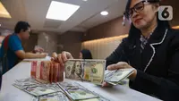 Mengakhiri perdagangan Senin (13/1/2025), rupiah melemah 0,57% atau 93 poin ke level Rp16.283 per dolar AS. (Liputan6.com/Angga Yuniar)
