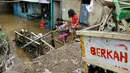 Warga melintasi banjir yang mulai memasuki belasan rumah warga di RT 11/ RW 07 sejak pukul 01.00 WIB dini hari tadi, Jakarta, Senin (16/11/2015). Ketinggian air mencapai 3 meter saat subuh dan merendam puluhan rumah. (Liputan6.com/Yoppy Renato)