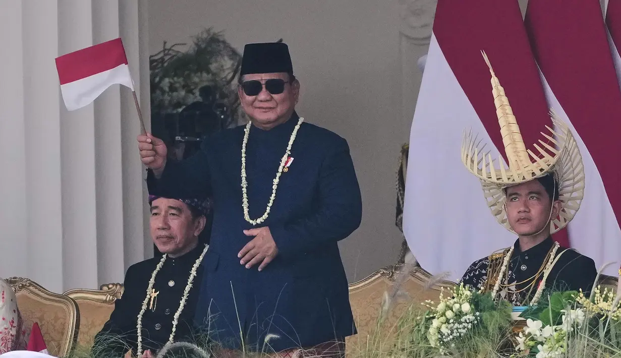 Presiden Prabowo Subianto  melambaikan bendera nasional Merah Putih, sementara Wakil Presiden Gibran Rakabuming Raka (kanan) dan mantan Presiden Joko Widodo menyaksikan, dalam upacara peringatan HUT ke-81 kemerdekaan RI di Istana Merdeka, Jakarta, Indonesia, Senin, 17 Agustus 2026. (Foto AP/Tatan Syuflana)