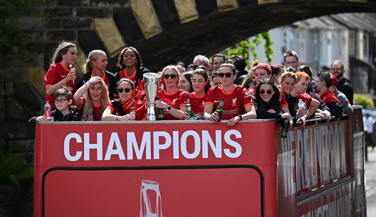 Para pemain Liverpool wanita mengikuti parade di atas bus terbuka dengan membawa trofi Kejuaraan Wanita untuk menyusuri jalan-jalan kota Liverpool pada Minggu (29/05/2022) waktu setempat. (AFP/Oli Scarff)