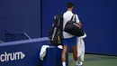 Petenis Serbia, Novak Djokovic, meninggalkan lapangan usai didiskualifikasi pada AS Terbuka di Flushing Meadows, Senin (7/9/2020). Djokovic didiskualifikasi karena memukulkan bola tenis ke arah hakim garis. (AP/Seth Wenig)