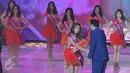 Finalis Miss Celebrity Indonesia 2015, Yuliana Woza Savitri (kiri) asal Bandung menerima buket bunga usai meraih gelar Miss Persahabatan pada malam grand final di Studio 6 Emtek City, Jakarta, Jumat (23/10) malam. (Liputan6.com/Herman Zakharia)