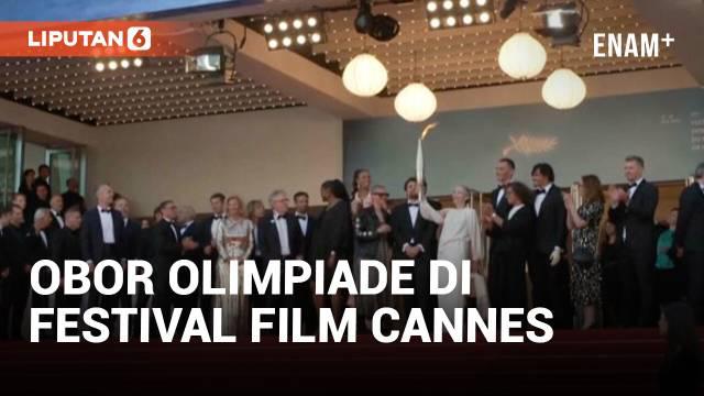 Obor Olimpiade dibawa di karpet merah Festival Film Cannes pada Selasa saat pemutaran perdana film "Marcello Mio" yang dibintangi oleh Catherine Deneuve dan putrinya, Chiara Mastroianni. Paralimpian Prancis Arnaud Assoumani menyalakan obor tersebut s...