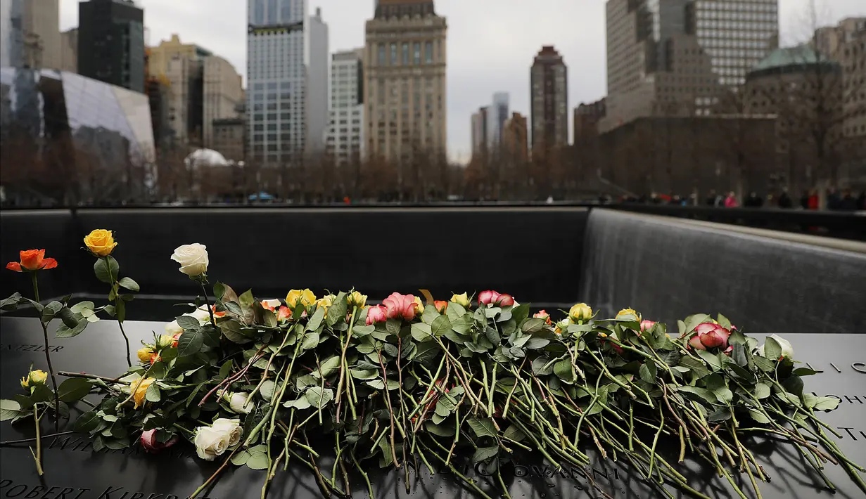 Orang-orang menaruh bunga mawar dalam peringatan 25 tahun serangan bom truk di WTC, New York City, Amerika Serikat, Senin (26/2). (Spencer Platt/Getty Images/AFP)