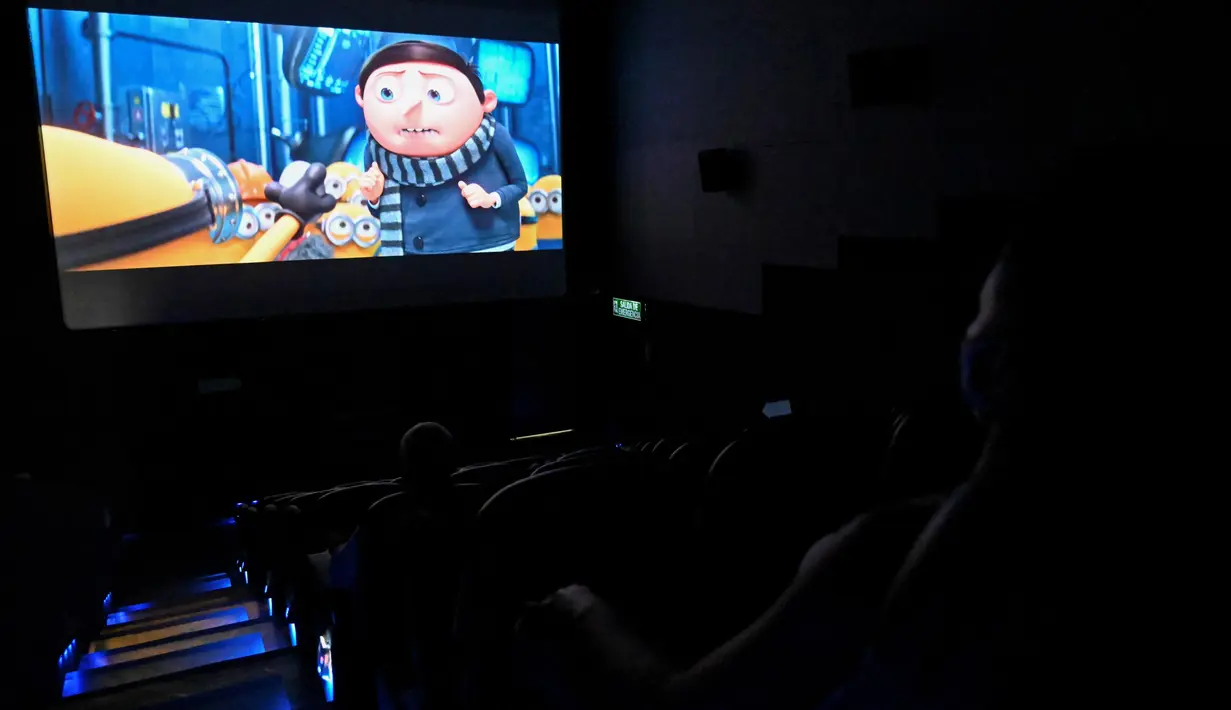 Orang-orang menonton film di bioskop yang dibuka kembali menyusul pelonggaran langkah-langkah yang diberlakukan oleh pemerintah Kolombia untuk menghentikan penyebaran Covid-19, di Cali, Kolombia pada Jumat (2/10/2020). (Photo by Luis ROBAYO / AFP)