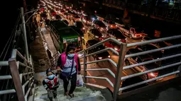 Warga menaiki JPO di tengah kepadatan lalu lintas di Manila, Filipina (3/8/2020). Kemacetan terjadi ketika orang-orang bergegas keluar dari Metro Manila beberapa jam sebelum pemerintah memberlakukan lockdown di kawasan itu akibat lonjakan kasus penyakit Covid-19. (Xinhua/Rouelle Umali)