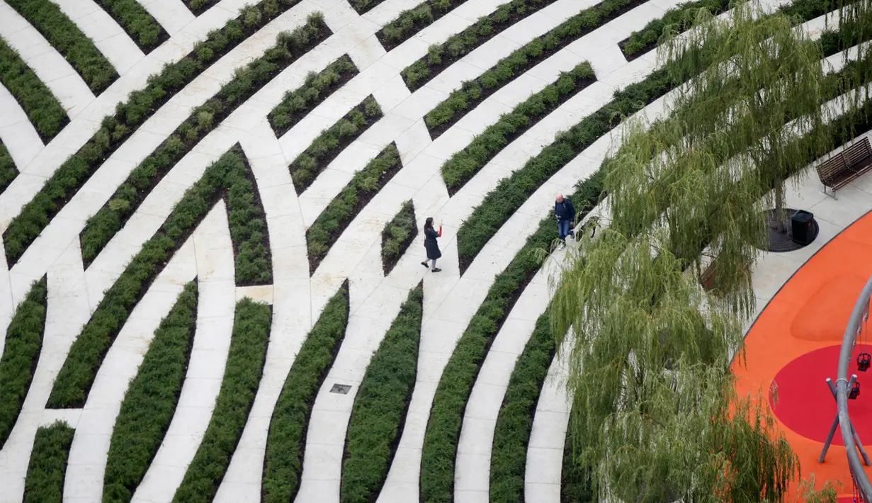 Pengunjung menyusuri jalan saat pembukaan 'Perpustakaan Pohon' di Milan, Italia, Sabtu (27/10). Perpustakaan ini memiliki luas hampir 10 hektare. (AP Photo/Luca Bruno)