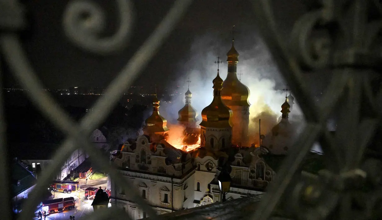 Asap dan api membubung dari Katedral Dormition, kompleks Ortodoks Kyiv Pechersk Lavra setelah serangan rudal Rusia di ibu kota Ukraina, Kyiv, Senin 15 Juni 2026, di tengah invasi Rusia. (Genya Savilov/AFP)
