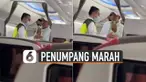Seorang petugas dengan rompi jadi sasaran amarah penumpang berjaket putih.