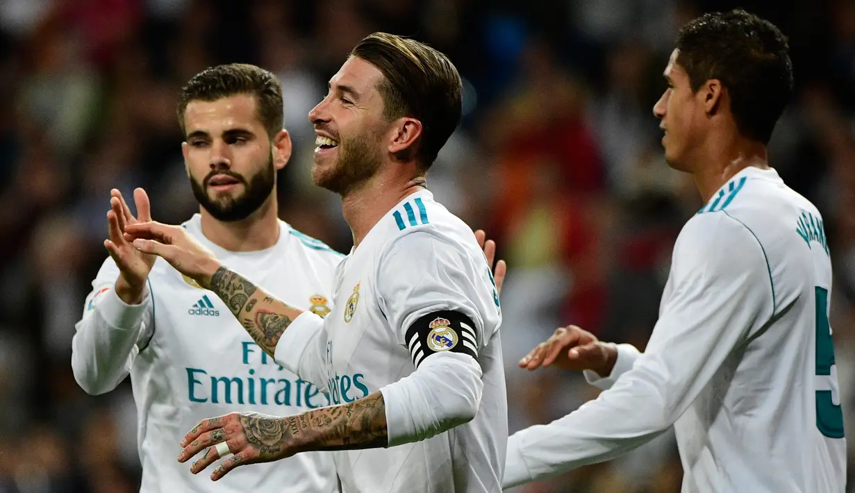 Bek Real Madrid, Sergio Ramos (tengah) dan timnya merayakan gol bunuh diri pemain Eibar, Paulo Oliveira dalam lanjutan La Liga pekan kesembilan di Stadion Santiago Bernabeu, Minggu (22/10). Madrid menang tiga gol tanpa balas (PIERRE-PHILIPPE MARCOU / AFP)