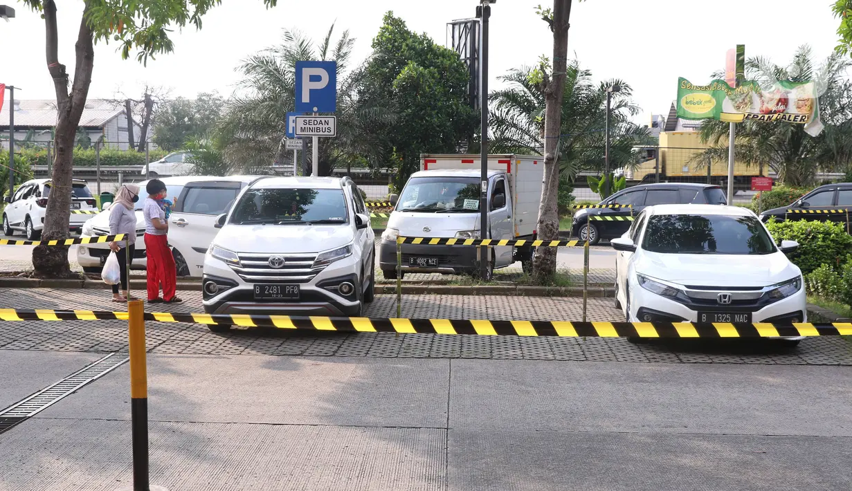 Sejumlah mobil terparkir berjarak di Rest Area KM 13,5 Palm Square Tol Jakarta-Tangerang, Jumat (29/5/2020). Penerepan parkir berjarak dan pengecekan suhu tubuh di area tersebut diberlakukan untuk menekan penyebaran Covid-19. (Liputan6.com/Angga Yuniar)