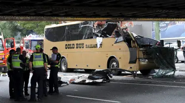 Sebuah bus terlihat menabrak kolong jembatan kereta di Montague, South Melbourne, Australia (22/2). Bus wisata yang membawa 19 penumpang tersebut menabrak pembatas kolong jembatan yang memiliki tinggi 10 kaki (3 meter). (REUTERS/Mal Fairclough)