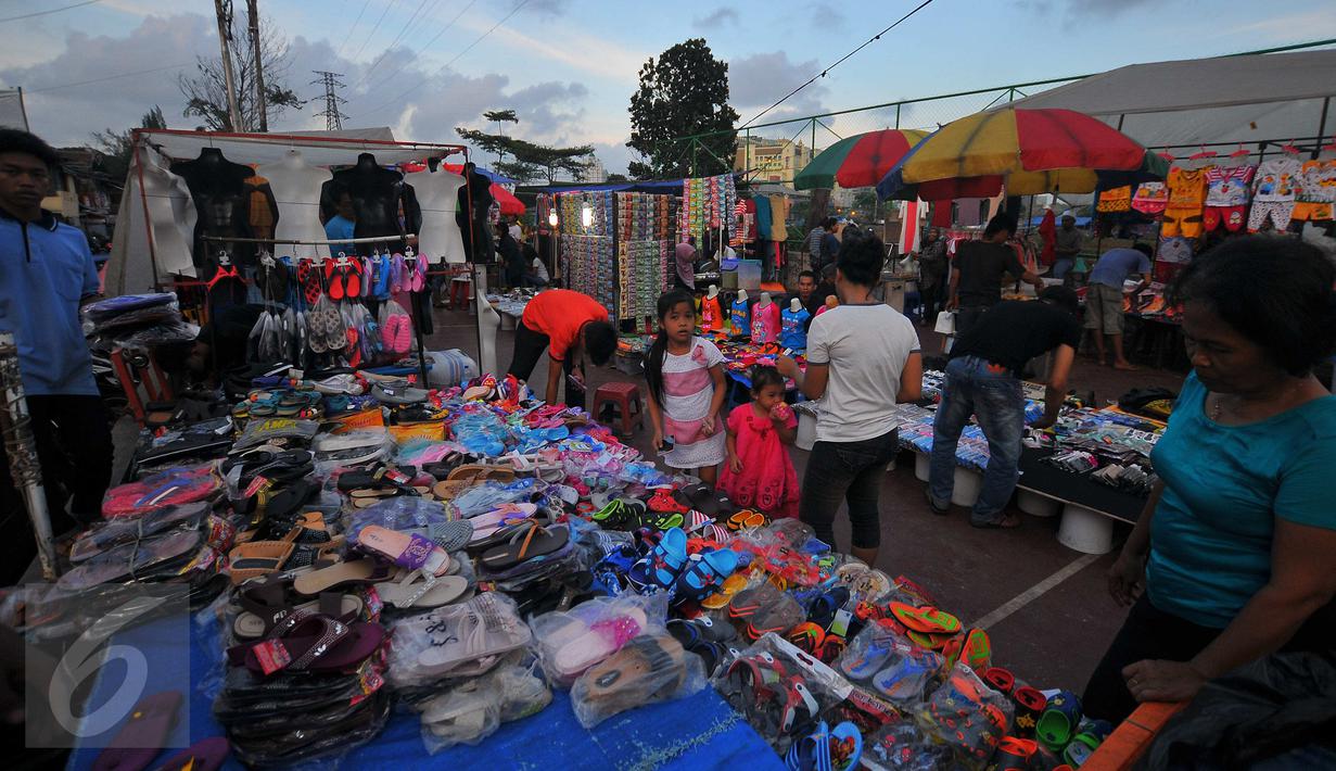 Pedagang menyiapkan barang dagangan jelang pasar malam di Petamburan, Jakarta, Selasa (10/1). Pasar malam menjadi alternatif belanja golongan menengah ke bawah. (Liputan6.com/Angga Yuniar)
