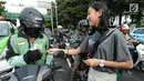 Sejumlah mahasiswi membagikan stiker kepada pengendara saat mengampanyekan keselamatan berlalu lintas di Jakarta, Rabu (20/3). Aksi ini mengajak pengendara untuk tertib berlalu lintas dengan #SelamatDijalan. (merdeka.com/Imam Buhori)