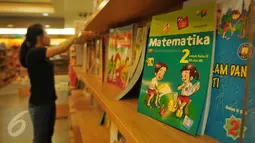 Pegawai merapihkan buku pelajaran di sebuah toko buku di Jakarta, (12/7). Menjelang dimulainya tahun ajaran baru 2016/2017 penjualan buku materi pelajaran dan buku tulis di toko buku mengalami peningkatan sekitar 50 persen. (Liputan6.com/Gempur M Surya)