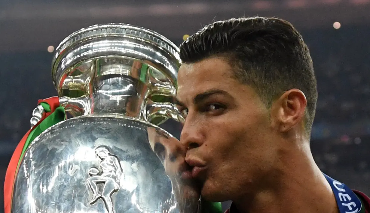 Cristiano Ronaldo mencium trofi juara Piala Eropa 2016 di Stade de France, Saint-Denis, Senin (11/7/2016) dini hari WIB. (AFP/Francisco Leong)