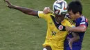 Pemain belakang Jepang, Yasuyuki Konno (kanan) berusaha menahan penyerang Kolombia, Adrian Ramos, saat berlaga di penyisihan Piala Dunia Grup C di Stadion Pantanal, Cuiaba, Brasil, (25/6/2014). (REUTERS/Suhaib Salem)
