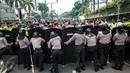 Polisi anti huru hara menjaga aksi ratusan orang Papua yang berdomisili di Jawa dan Bali saat memperingati 1 Desember di Bundaran HI, Jakarta, Selasa (1/12). Tanggal 1 Desember juga diartikan sebagai hari kemerdekaan Papua. (Liputan6.com/Faizal Fanani)