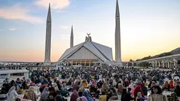 Umat Muslim di Pakistan, lebih banyak berbuka puasa bersama keluarga dan kerabat di masjid. (Aamir Qureshi/AFP)
