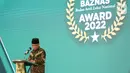 Menko PMK Muhadjir Effendy memberi sambutan pada BAZNAS Award 2022 di Jakarta, Senin (17/01/2022). Muhadjir menerima penghargaan sebagai Tokoh Pendukung Gerakan Zakat Indonesia, dan sejumlah tokoh dari lembaga pemerintah maupun non-pemerintah. (Liputan6.com/Fery Pradolo)