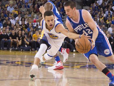 Pemain Warriors, Stephen Curry (30)mencoba merebut bola dari pemain Philadelphia 76ers, T.J. McConnell (12) pada lanjutan NBA di Oracle Arena, Minggu (27/3/2016). Warriors menang atas 76ers 117-105. (Mandatory Credit: Kyle Terada-USA TODAY Sports)