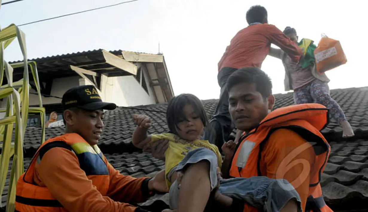 Petugas Basarnas mengevakuasi warga ketika banjir melanda Perumahan Ciledug Indah 1, Tangerang, Selasa (10/2/2015). Banjir merendam ratusan rumah di kawasan tersebut dengan ketinggian mencapai 90 cm. (Liputan6.com/Andrian M Tunay)
