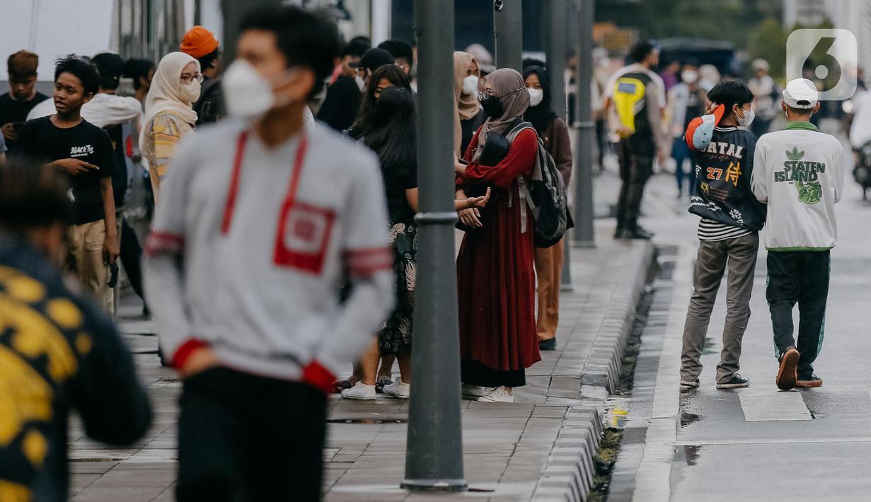 Ratusan remaja dari berbagai daerah di pinggiran Jakarta berkumpul di Taman Sudirman, Jakarta, Rabu (6/7/2022). Tempat ini viral karena jadi ajang adu fashion anak Citayam, Bekasi hingga Bojong Gede. Mereka mengenakan kemeja flanel oversize, celana model 90-an seperti boot cut atau cutbray, sneakers klasik, dan topi. (Liputan6.com/Faizal Fanani)
